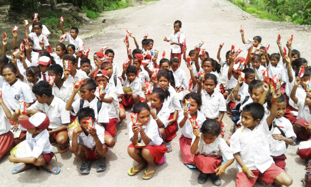 Happy children enjoy their snacks